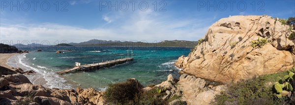 Rock formations, jetty leading into the sea, panoramic shot, Capriccioli beach, Costa Smeralda, Sardinia, Italy, Europe