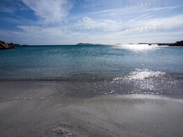 Waves reach the sandy beach, glittering sea, Capriccioli beach, Costa Smeralda, Sardinia, Italy, Europe