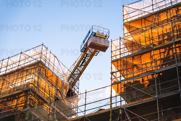 Scaffolding and crane at a construction site in the old harbour of Barcelona, Spain, Europe