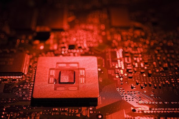 Close-up of red lighted microchip on electronic computer circuit board, Studio Composition, Quebec, Canada, North America