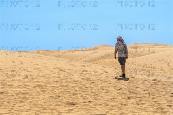 Portrait of male tourist in summer in the dunes of Maspalomas, Gran Canaria, Canary Islands