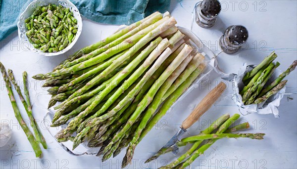 Green asparagus on a light-coloured base with salt shaker and pepper mill on the side, AI generated, AI generated