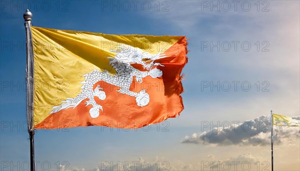 Flag, the national flag of Bhutan flutters in the wind