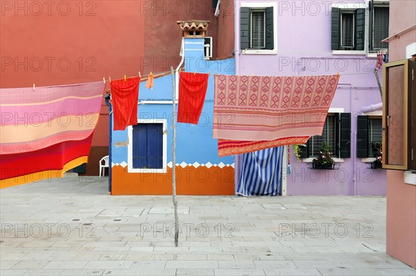 Colourful houses, Burano, Burano Island, Laundry hanging in front of pastel-coloured houses on an empty street, Burano, Venice, Veneto, Italy, Europe