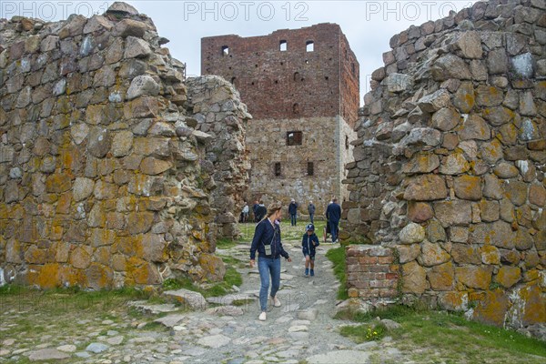 Tourists in Hammershus which was Scandinavia's largest medieval fortification and is one of the largest medieval fortifications in Northern Europe. Now ruin and located on the island Bornholm, Denmark, Baltic Sea, Scandinavia, Europe