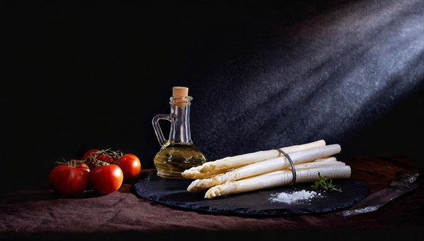 Asparagus spears next to olive oil and tomatoes staged with dramatic lighting, AI generated, AI generated