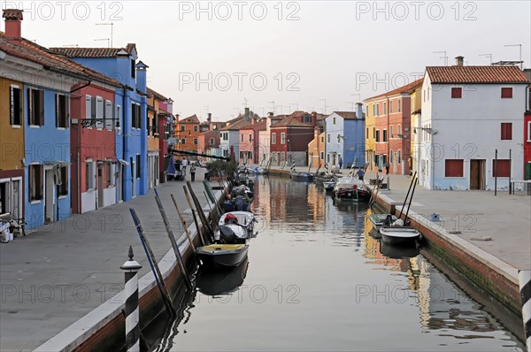 Colourful houses, Burano, Burano Island, The tranquil scene of a canal with reflections of boats and colourful houses in the evening, Burano, Venice, Veneto, Italy, Europe