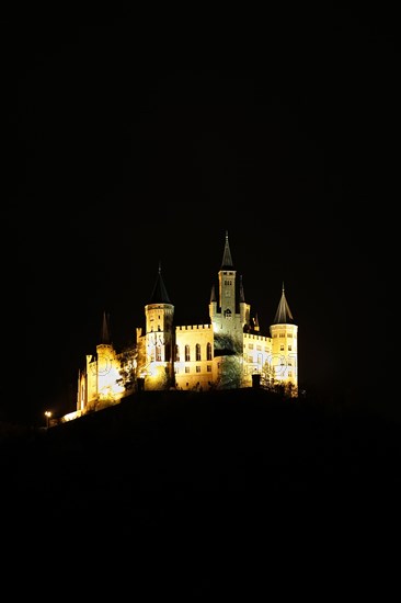 Hohenzollern Castle, ancestral castle of the princely family and former ruling Prussian royal and German imperial house of Hohenzollern, summit castle, historical building by the Berlin architect Friedrich August Stueler, architecture, neo-Gothic, castle building, aristocratic residence, west view, night view, illumination, artificial light, Bisingen, Zollernalbkreis, Baden-Wuerttemberg, Germany, Europe