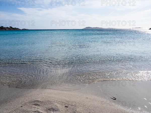 Waves reach the sandy beach, glittering sea, Capriccioli beach, Costa Smeralda, Sardinia, Italy, Europe