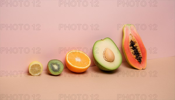 Variety of sliced fruits including citrus and avocado on a dual-tone pastel background, horizontal, AI generated