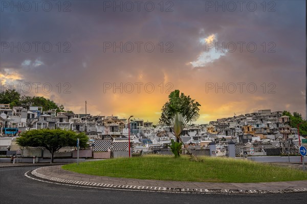 Famous cemetery, many mausoleums or large tombs decorated with tiles, often in black and white. Densely built buildings under a sunset Cimetiere de Morne-a-l'eau, Grand Terre, Guadeloupe, Caribbean, North America