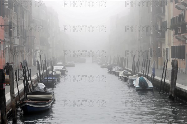 A foggy canal in Venice creates a mystical and tranquil atmosphere, Venice, Veneto, Italy, Europe