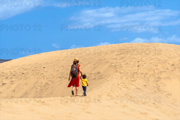 Mother and son enjoying in the dunes of Maspalomas on vacation, Gran Canaria, Canary Islands