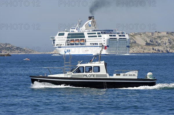 Marseille harbour, pilot boat on the sea off the coast, in the background a large ferry, Marseille, Departement Bouches-du-Rhone, Region Provence-Alpes-Cote d'Azur, France, Europe