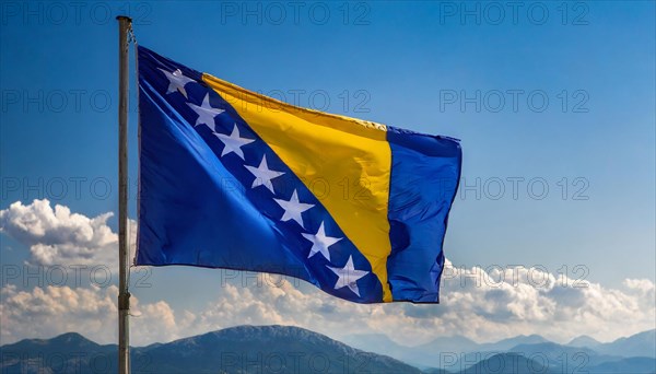 The flag of Bosnia and Herzegovina flutters in the wind, isolated against a blue sky