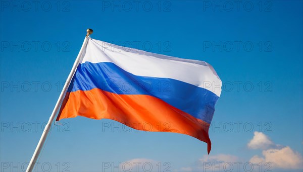 The flag of Russia flutters in the wind, isolated against a blue sky