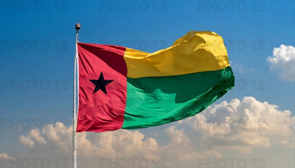 The flag of Guinea-Bissau, fluttering in the wind, isolated, against the blue sky