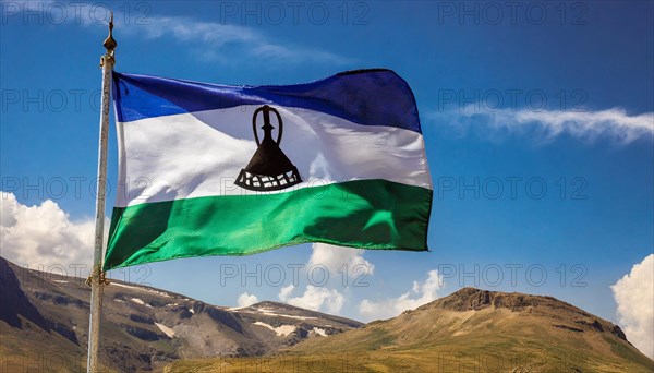 The flag of Lesotho, fluttering in the wind, isolated, against the blue sky