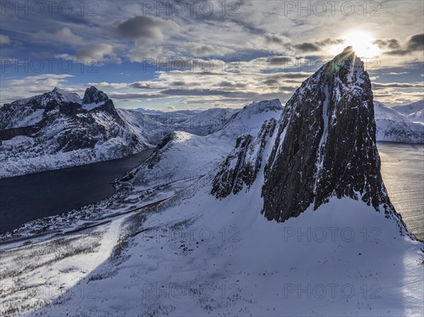 Aerial view of Bergen by the sea, fjord, sunbeams, winter, snow, Mount Segla, Senja, Troms, Norway, Europe