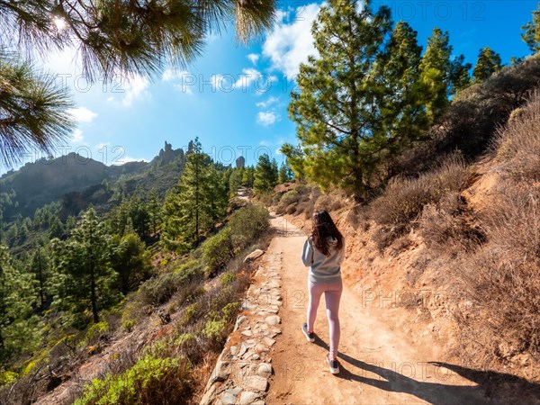 A woman hiker on the trail up to Roque Nublo in Gran Canaria, Canary Islands