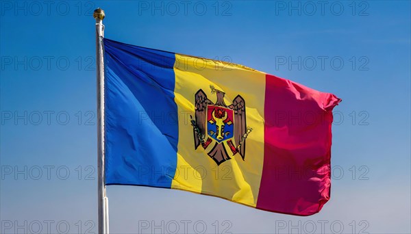 The flag of Moldova, Republic of Moldova, flutters in the wind, isolated against a blue sky