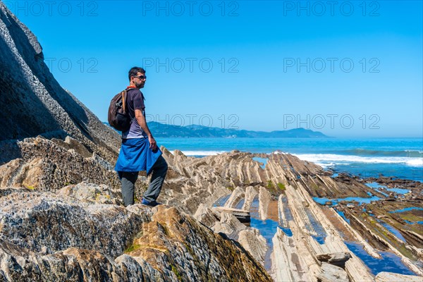 A hiker in the Flysch Basque Coast geopark in Zumaia, Gipuzkoa