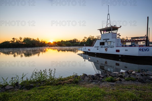 View of a river and its bank. the way to the city with a ferry. Landscape photograph of Seligenstadt, Hesse, Germany, Europe