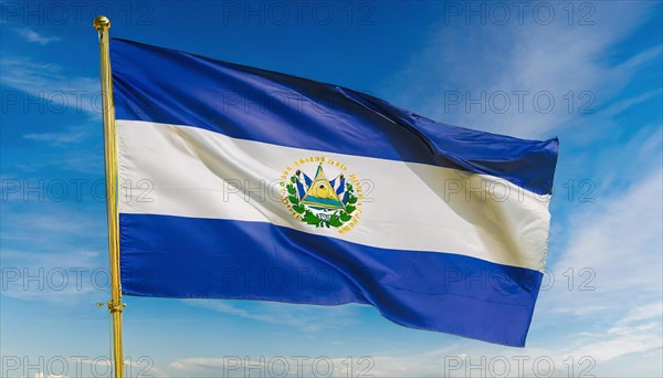 The flag of El Salvador flutters in the wind, isolated against a blue sky