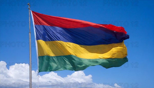 The flag of Mauritius, fluttering in the wind, isolated, against the blue sky