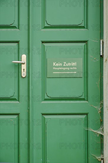 No entry, main entrance on the right, sign on a green front door in the historic city centre of Weimar, Thuringia, Germany, Europe