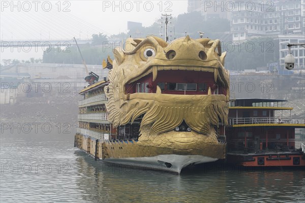 Yichang, Hubei Province, China, Asia, A ship in the shape of a golden dragon's head floats on a misty river, Asia