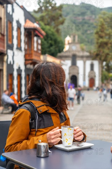 A tourist woman resting and having a coffee in the municipality of Teror. Gran Canaria, Spain, Europe