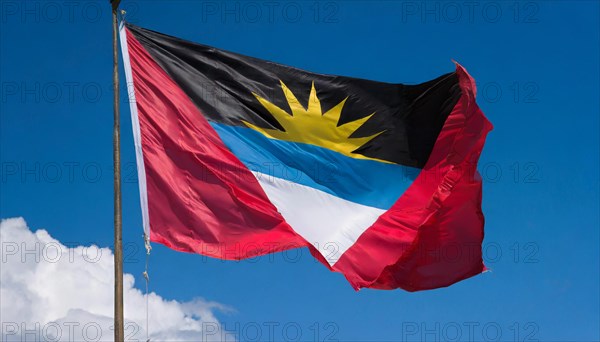 The flag of Antigua flutters in the wind, isolated against the blue sky