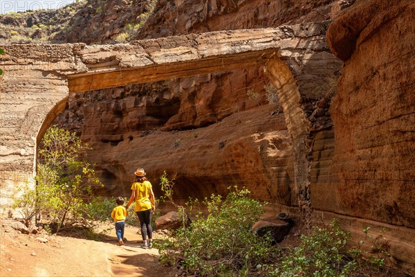 Family visiting the limestone canyon Barranco de las Vacas in Gran Canaria, Canary Islands