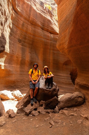 A tourist couple enjoying in the limestone canyon Barranco de las Vacas in Gran Canaria, Canary Islands