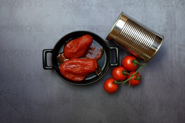 Whole tinned tomatoes in a pot, tomatoes and tins