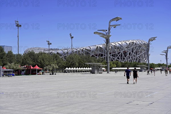Beijing, China, Asia, Spacious forecourt of a modern stadium with people under a clear blue sky, Asia