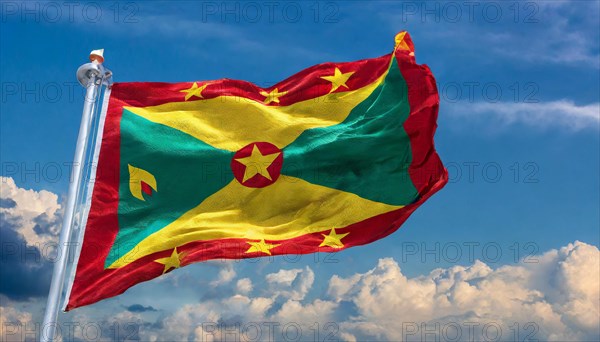 The flag of Grenada, Caribbean, flutters in the wind, isolated, against the blue sky