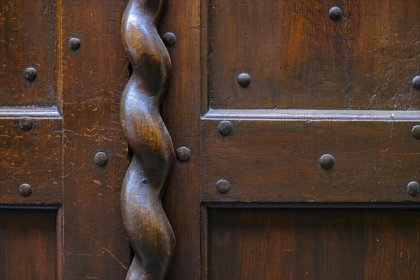 Application on wood, antiquated door fitting in the form of a spiral bar on a historic front door, Old Town Lindau (Lake Constance), Bavaria, Germany, Europe