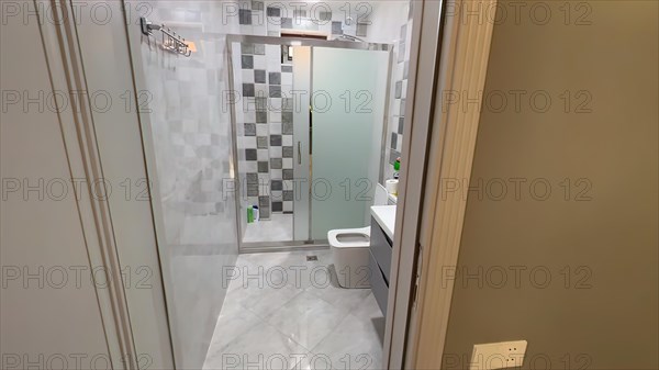 Interior of a modern bathroom with shower and toilet. Nobody inside