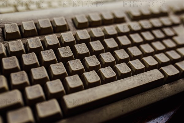 Old vintage computer mechanical keyboard in dust, computer keyboard from the 1980s