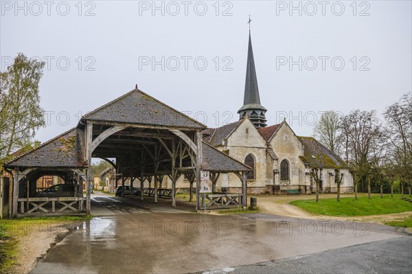 Open market hall and church in the village of Lesmont, Aube department, Grand Est region, France, Europe