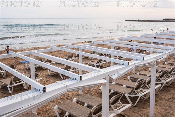 Empty sunbeds on the beach in Sitges, Spain, Europe