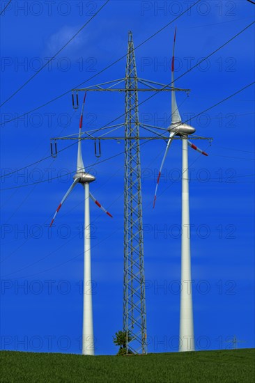 Power pylon with high-voltage lines and wind turbines at the Avacon substation Helmstedt, Helmstedt, Lower Saxony, Germany, Europe