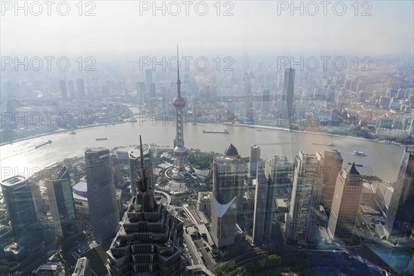 View from the 632 metre high Shanghai Tower, nicknamed The Twist, Shanghai, People's Republic of China, aerial view of a veiled city with skyscrapers and a river, Shanghai, China, Asia
