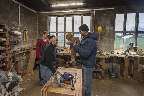 Family reunion in the workshop, father, daughter, son and grandson, Mecklenburg-Vorpommern, Germany, Europe