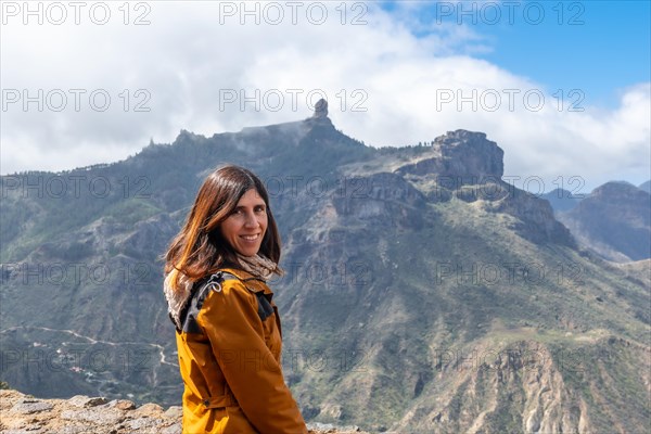 Portrait of a woman looking at Roque Nublo from a viewpoint on the mountain. Gran Canaria, Spain, Europe