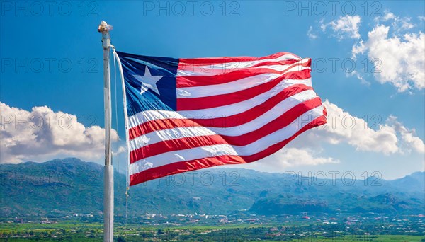 The flag of Liberia, fluttering in the wind, isolated, against the blue sky