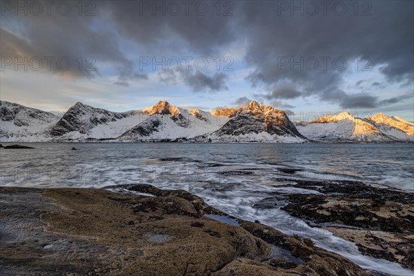 Rocky coast off Bergen, sea, waves, spray, morning mood with clouds, winter, Tungeneset, Senja, Troms, Norway, Europe