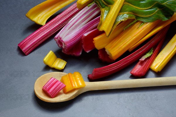 Red and yellow chard, wooden spoon and chopped stems, Beta vulgaris